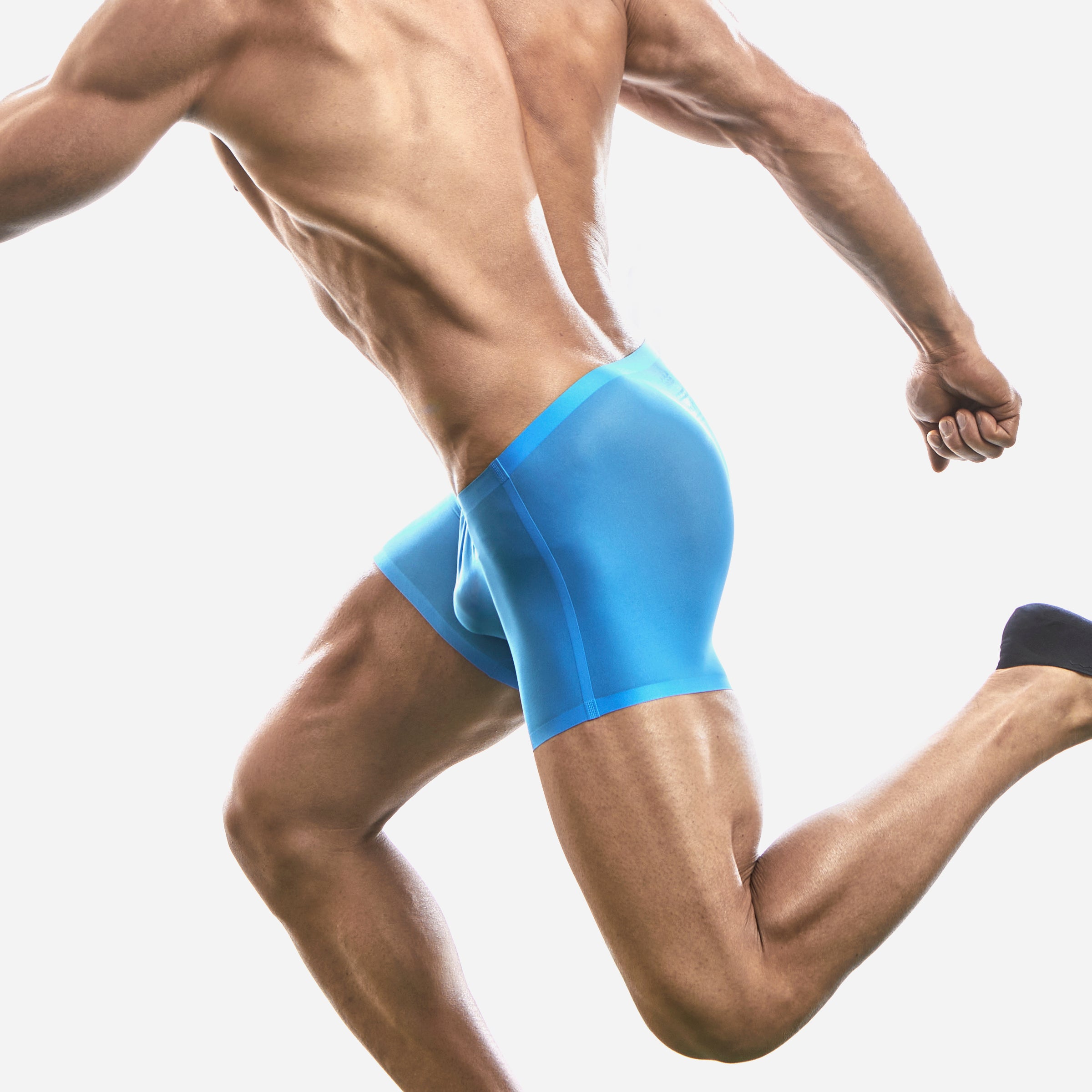 Side view of a man wearing a blue boxer brief on a white background